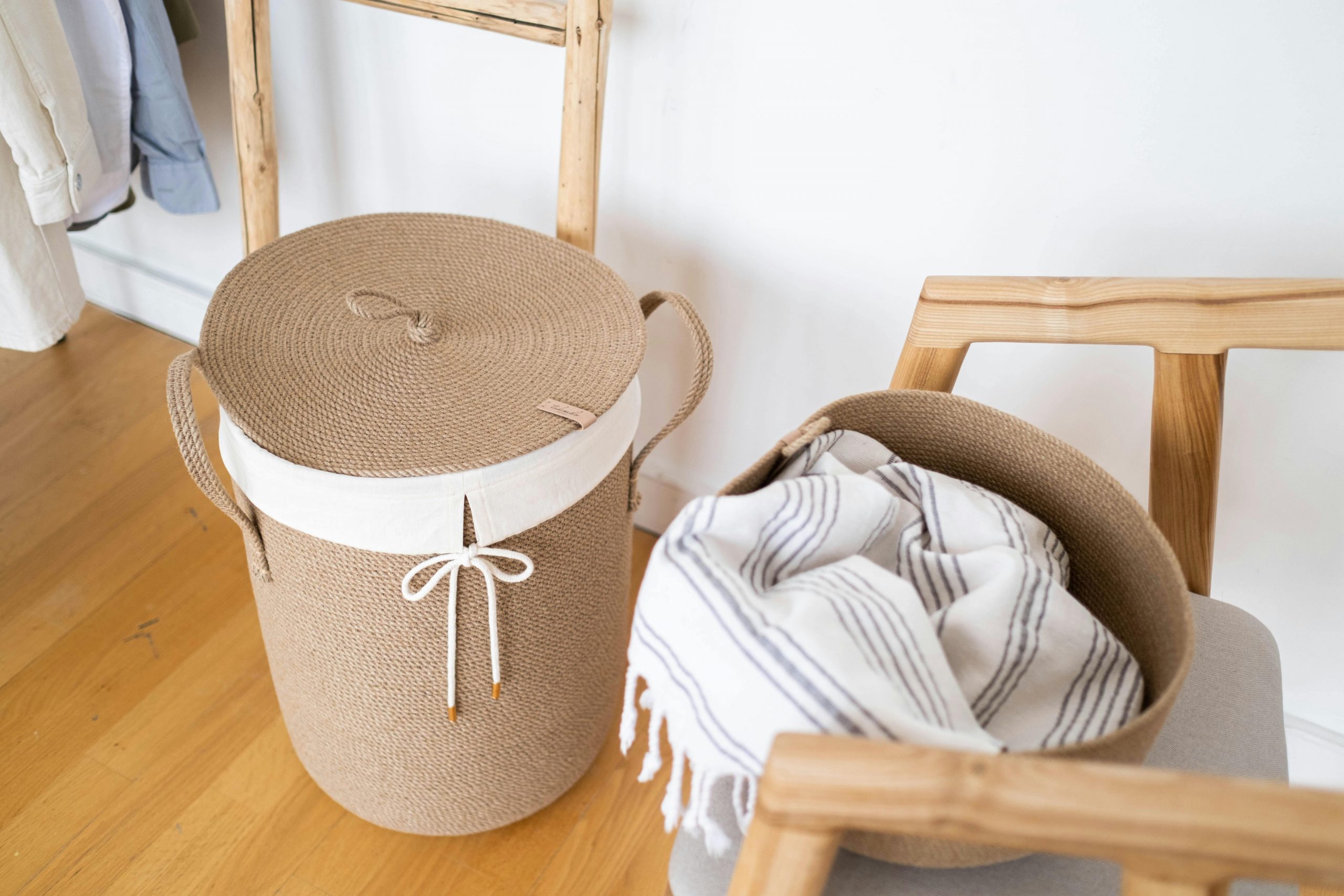 A cozy and stylish laundry setup featuring a woven basket and striped cloth indoors.